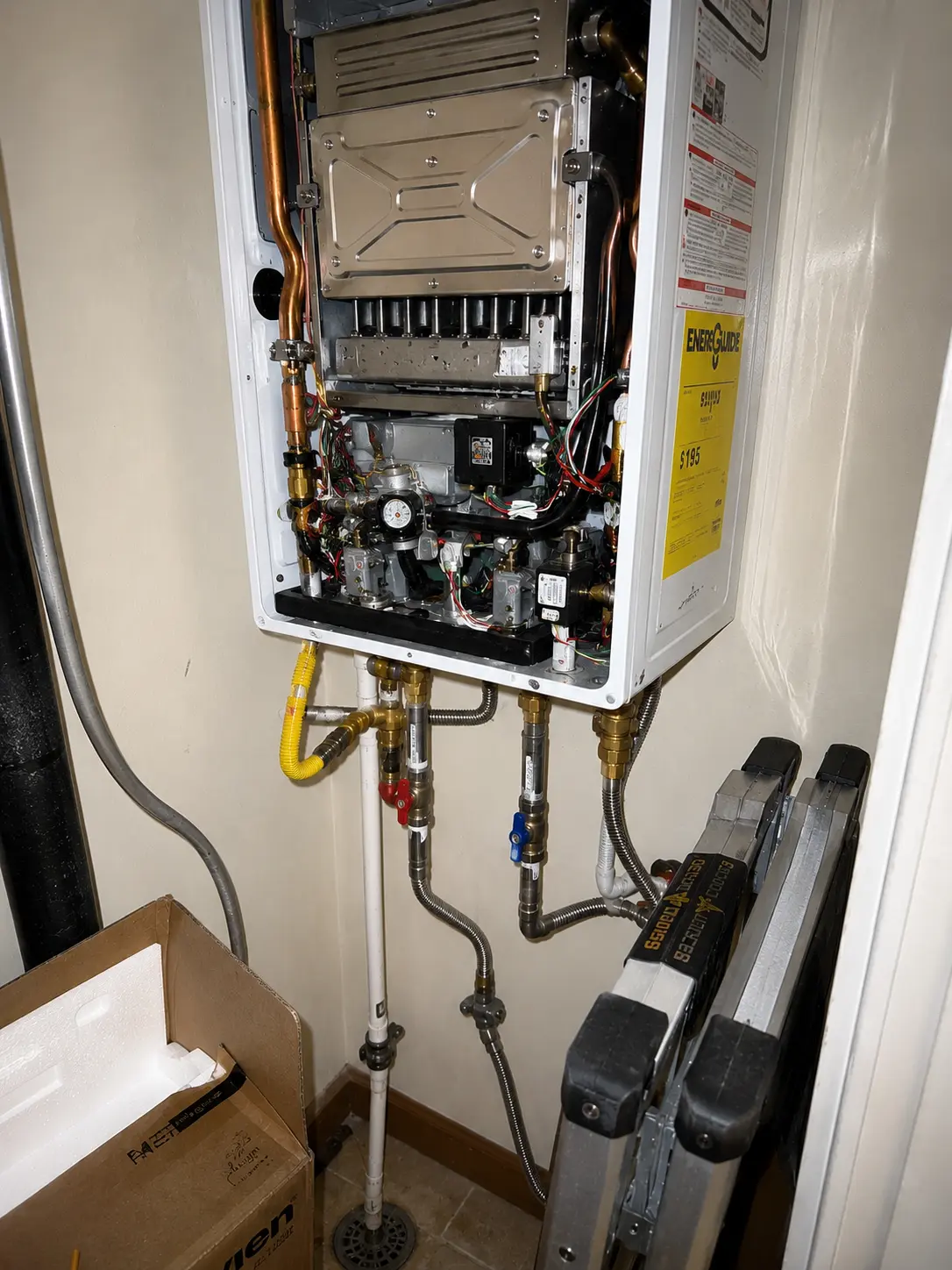 plumber working under a kitchen sink in a Brooklyn brownstone